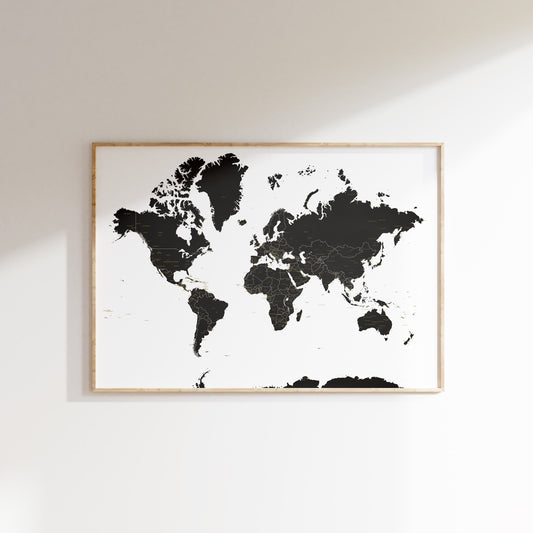 World map poster in a wooden frame on a white wall
