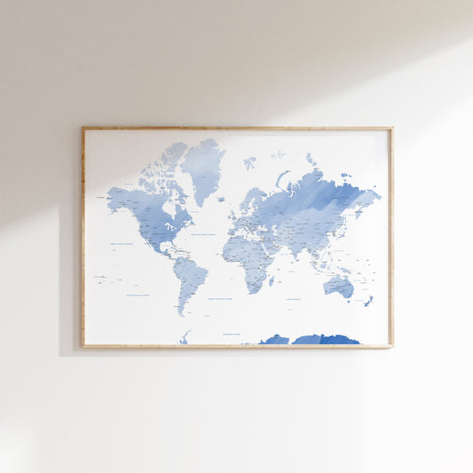 Blue watercolour world map wall art in a wood frame.