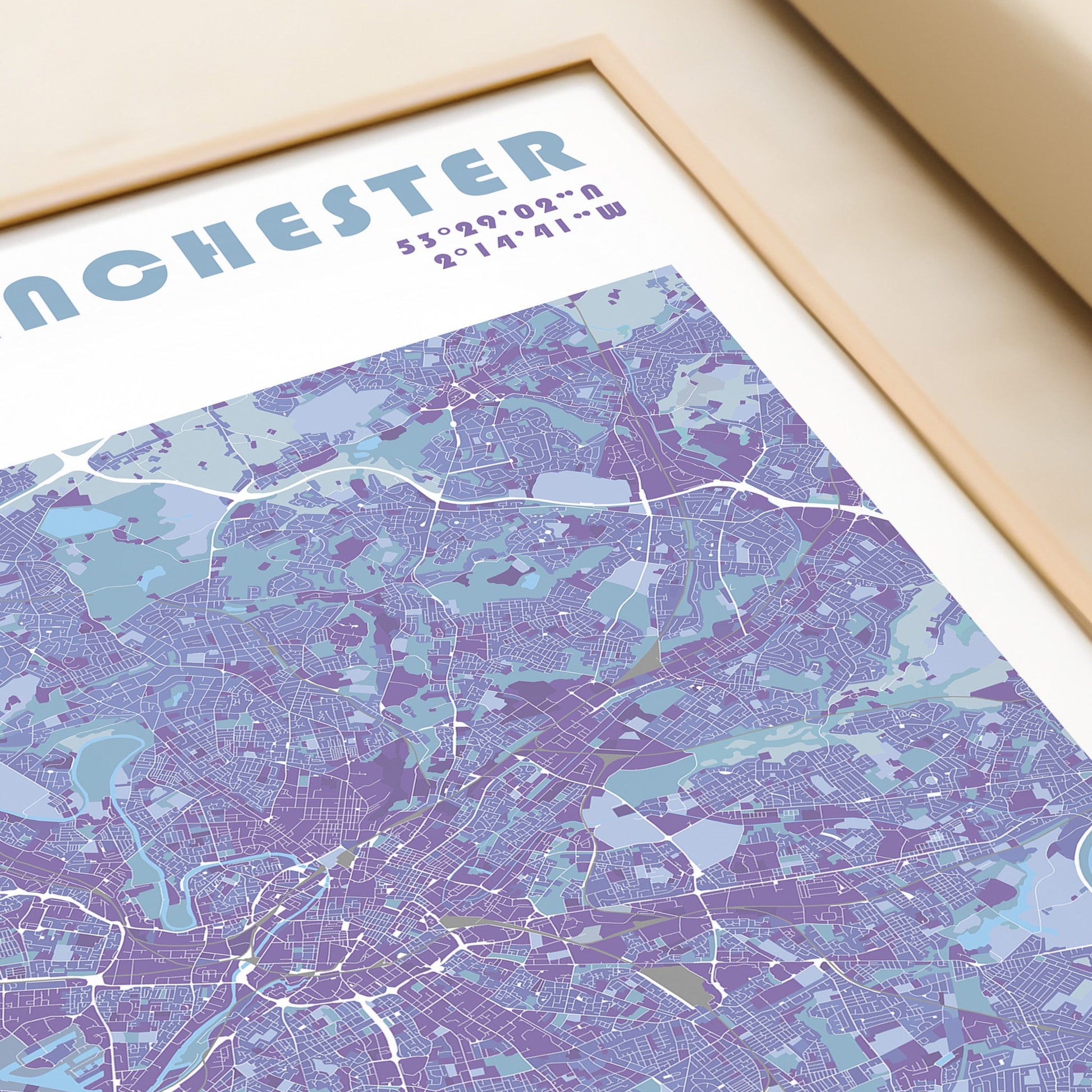 Manchester travel map poster in a wood frame.