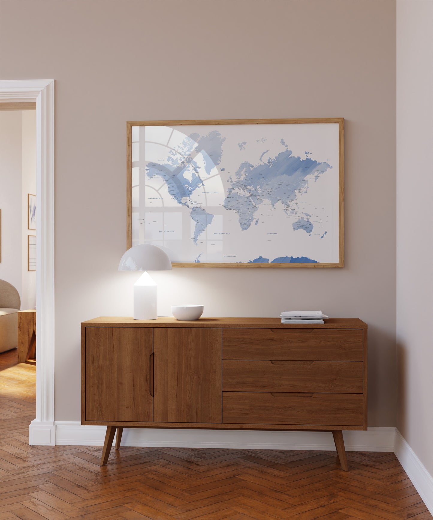 Blue watercolour world map wall art in a wood frame.