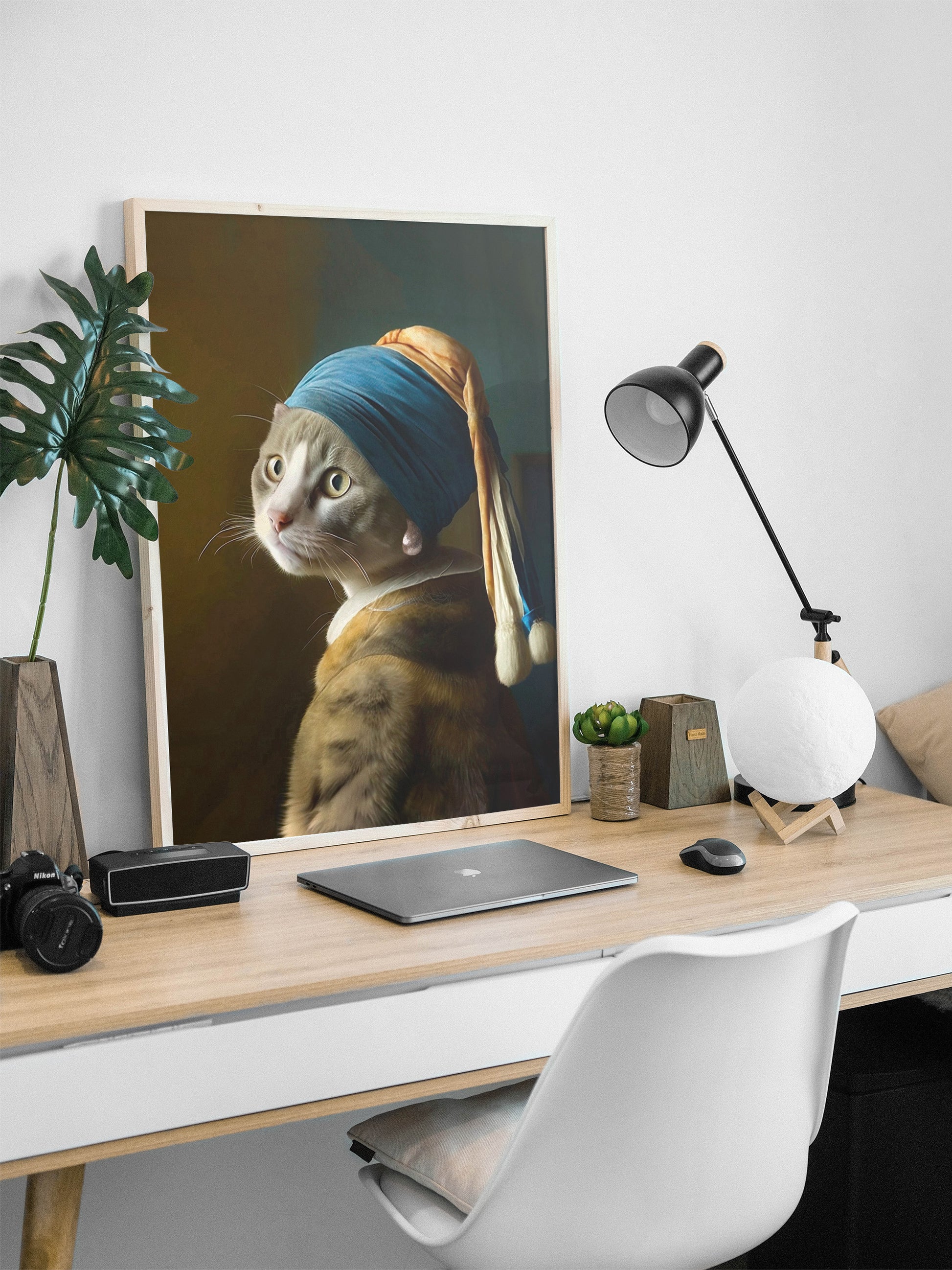 Grey cat with pearl earring wall art in a wood frame.