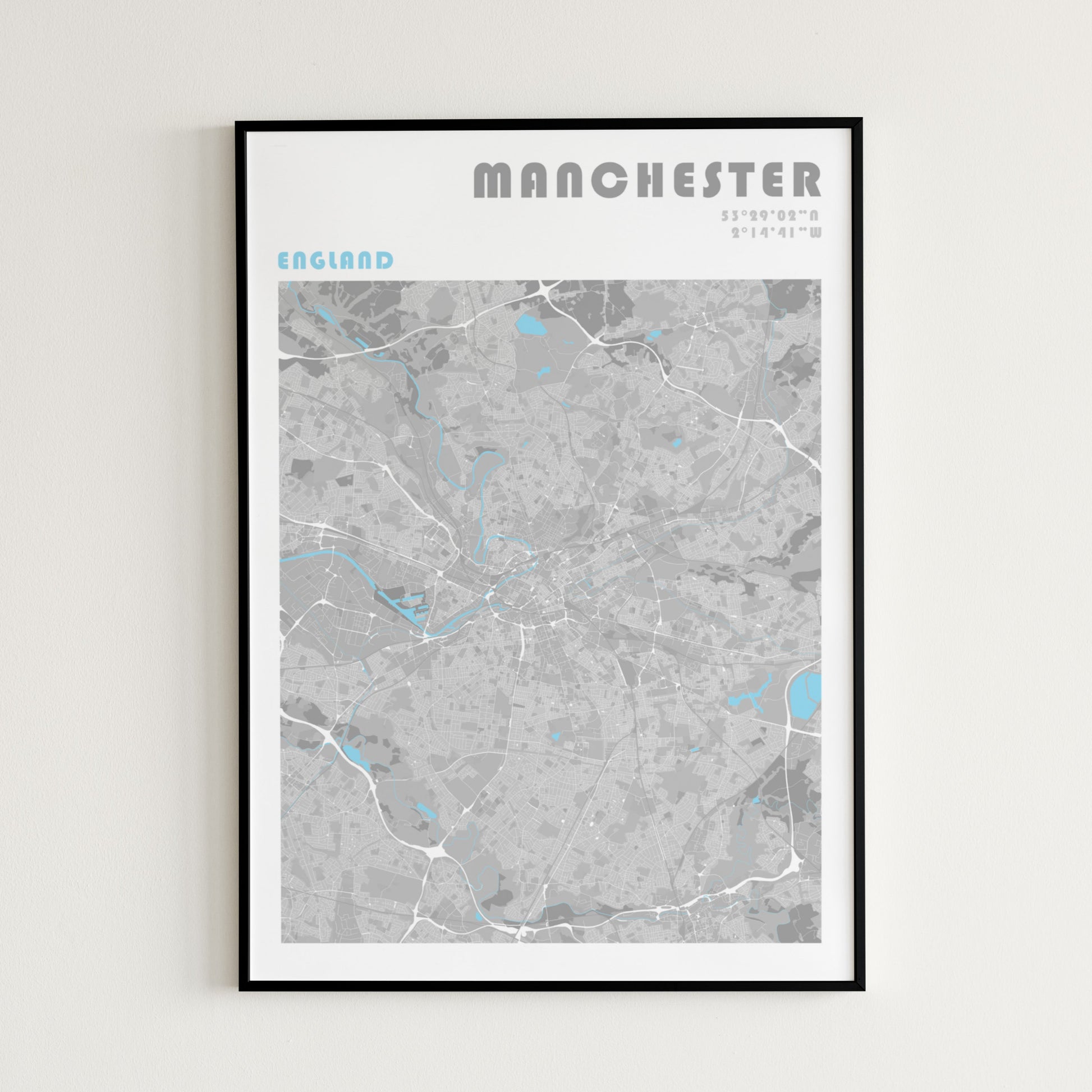 Manchester travel map poster in a black frame.