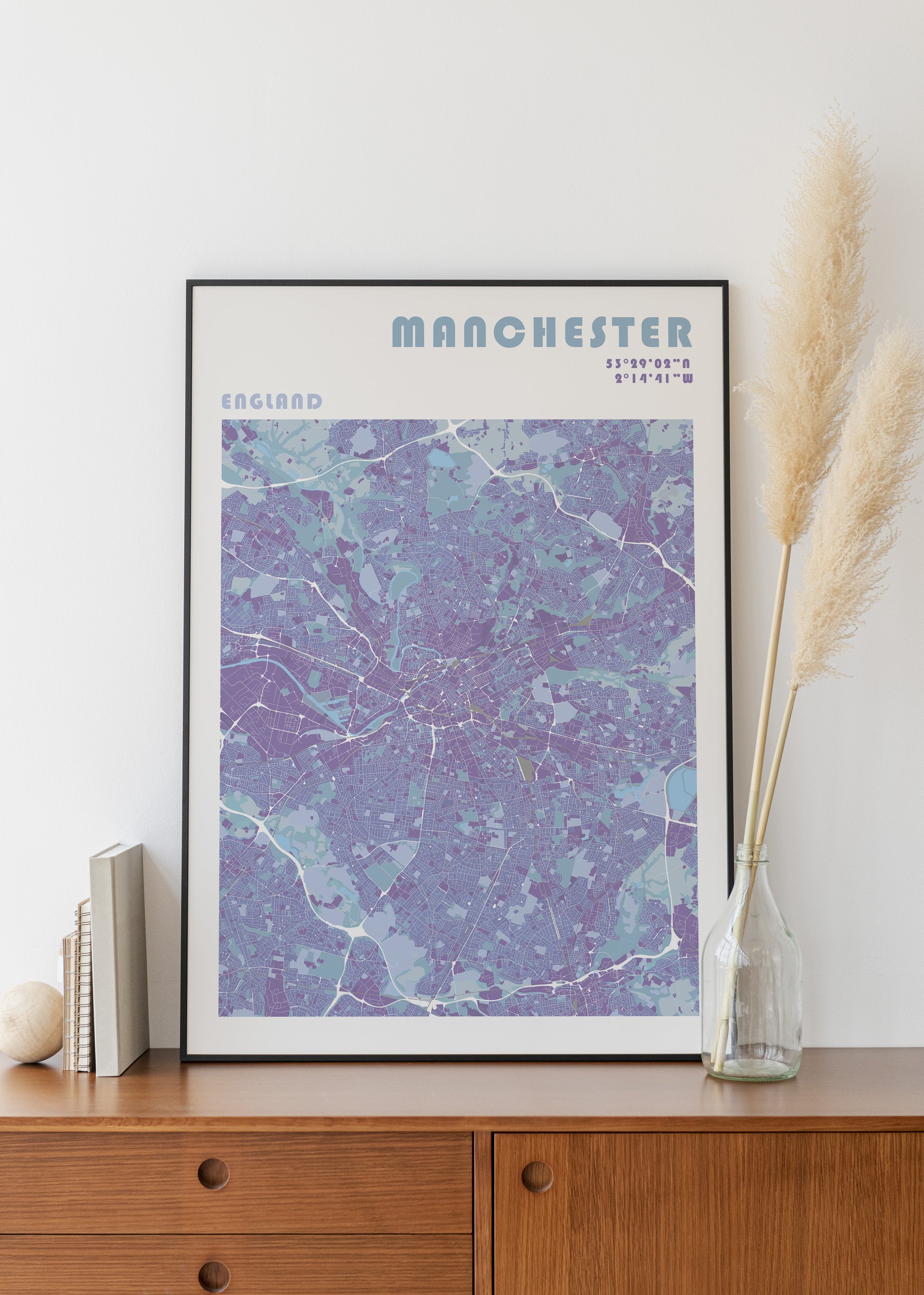 Manchester city print in a black metal frame.