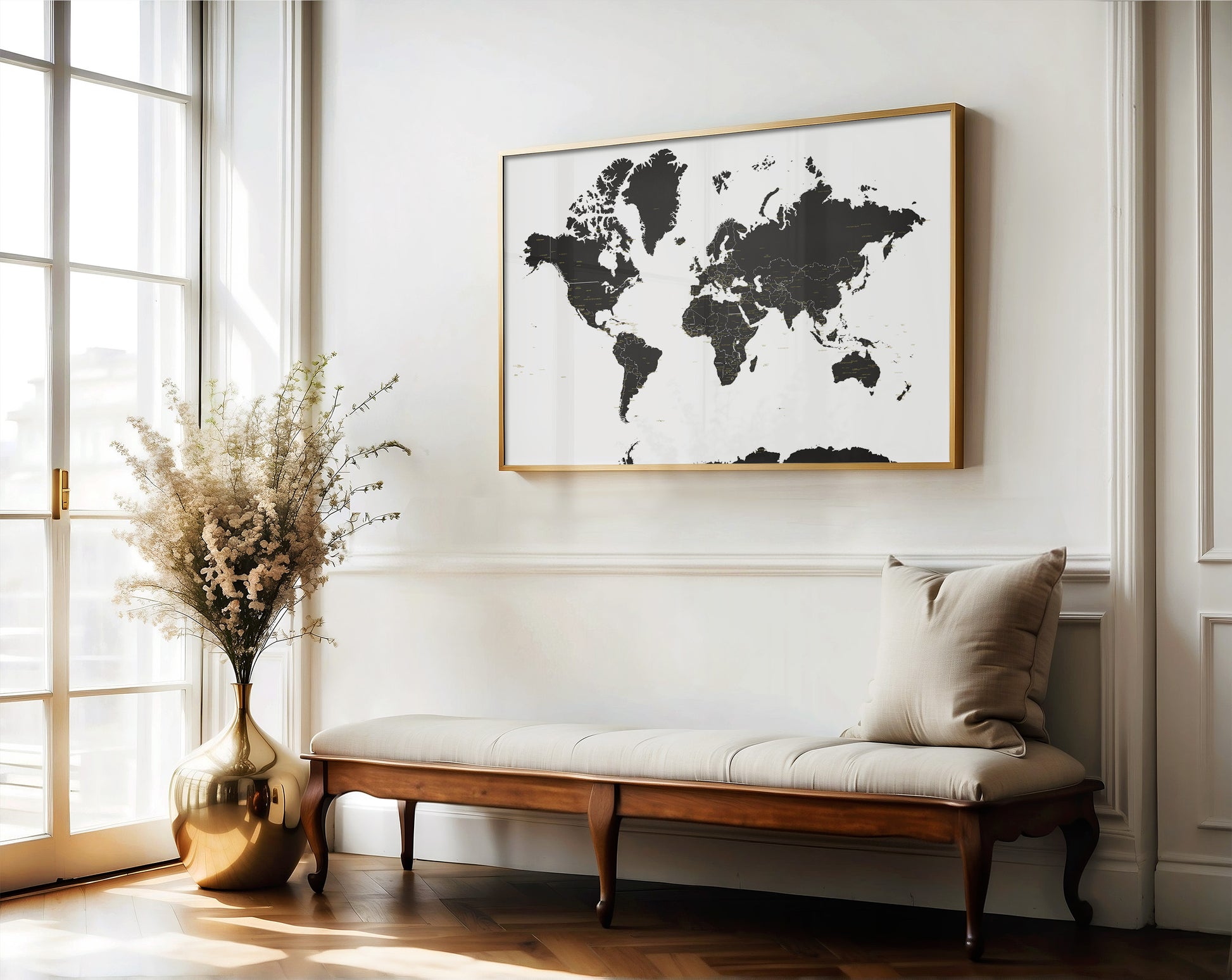 World map framed on a wall above a wooden bench with a decorative vase and plant.