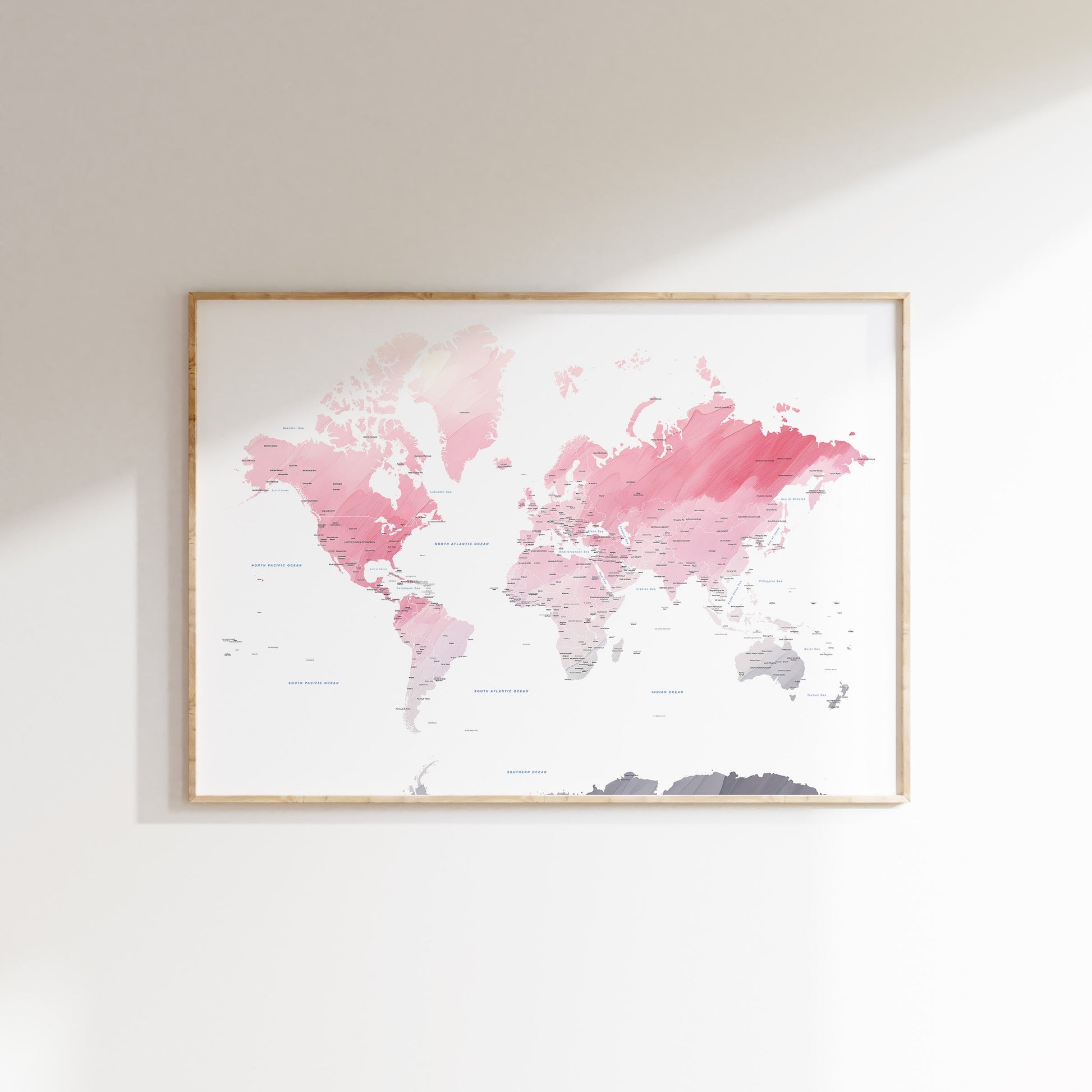 Watercolor world map art in a wood frame.