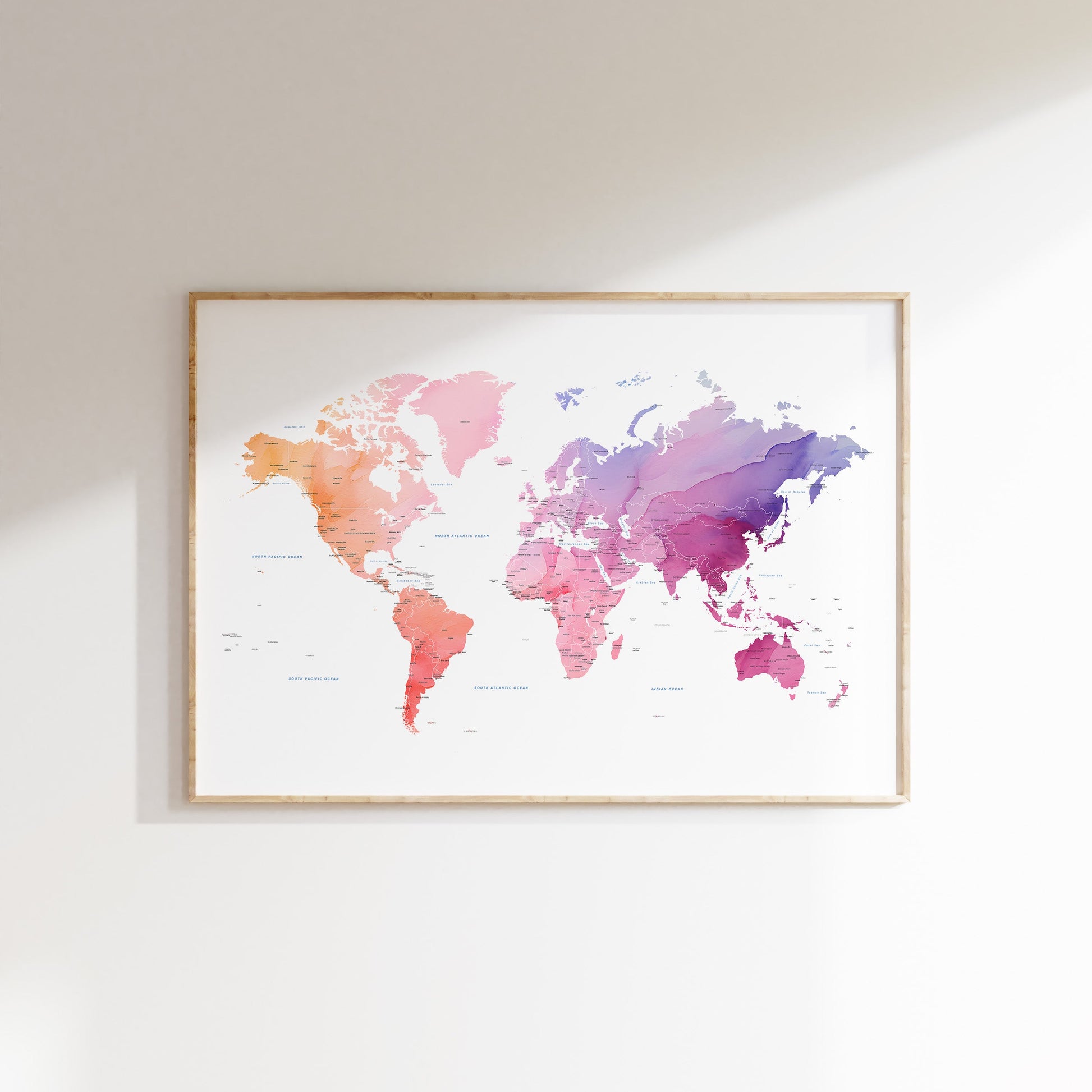 Watercolor world map wall art in a wood frame.