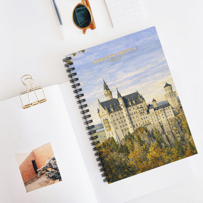 Notebook with the Neuschwanstein castle design on cover, placed on a white surface with a photo and clip.