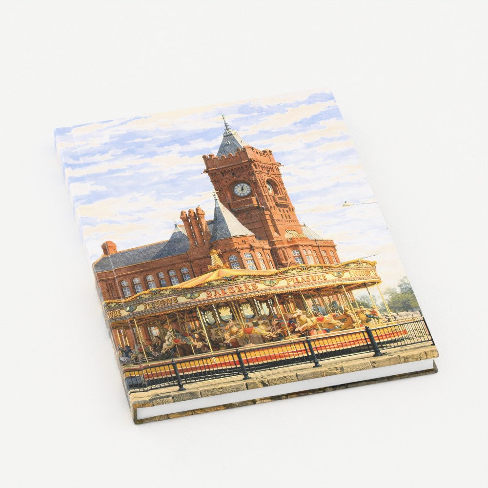 Notebook with a design of a clock tower and carousel on the cover
