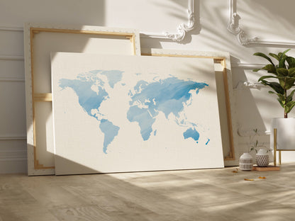 Watercolor world map canvas wall art in blue tones.