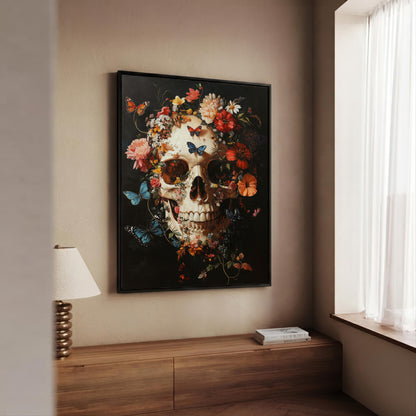 A framed wall art print featuring a detailed skull surrounded by colorful flowers and butterflies, displayed in a real interior setting above a wooden console table.