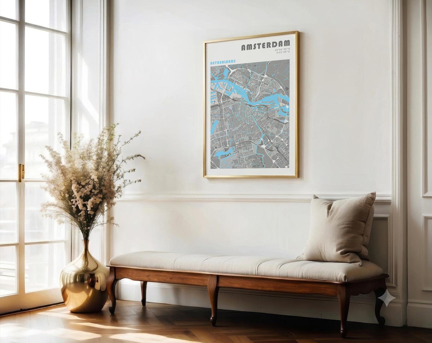 Framed map of Amsterdam on a wall above a wooden bench with a vase and flowers.