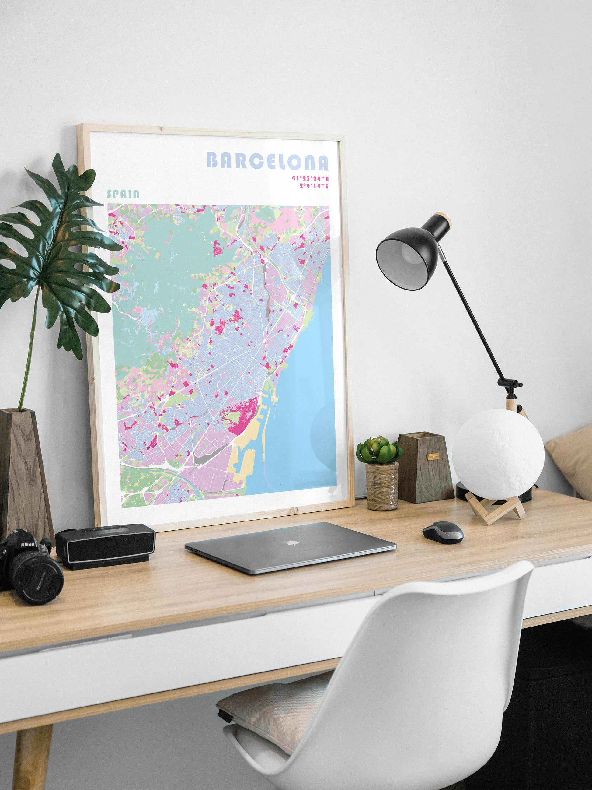 Barcelona city map print in a natural wood frame.