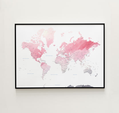 Watercolor world map print in a black metal frame.