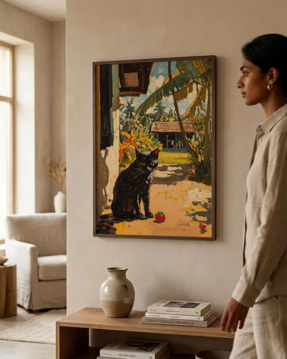 A framed painting of a black cat in a tropical garden hangs on a beige wall in a modern living room. A woman in a beige linen outfit stands to the right, looking at the artwork.