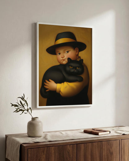 A framed art print depicting a classical-style portrait of a boy in a black hat with a yellow band, holding a black cat, hung on a white wall above a wooden console table with a vase and book.
