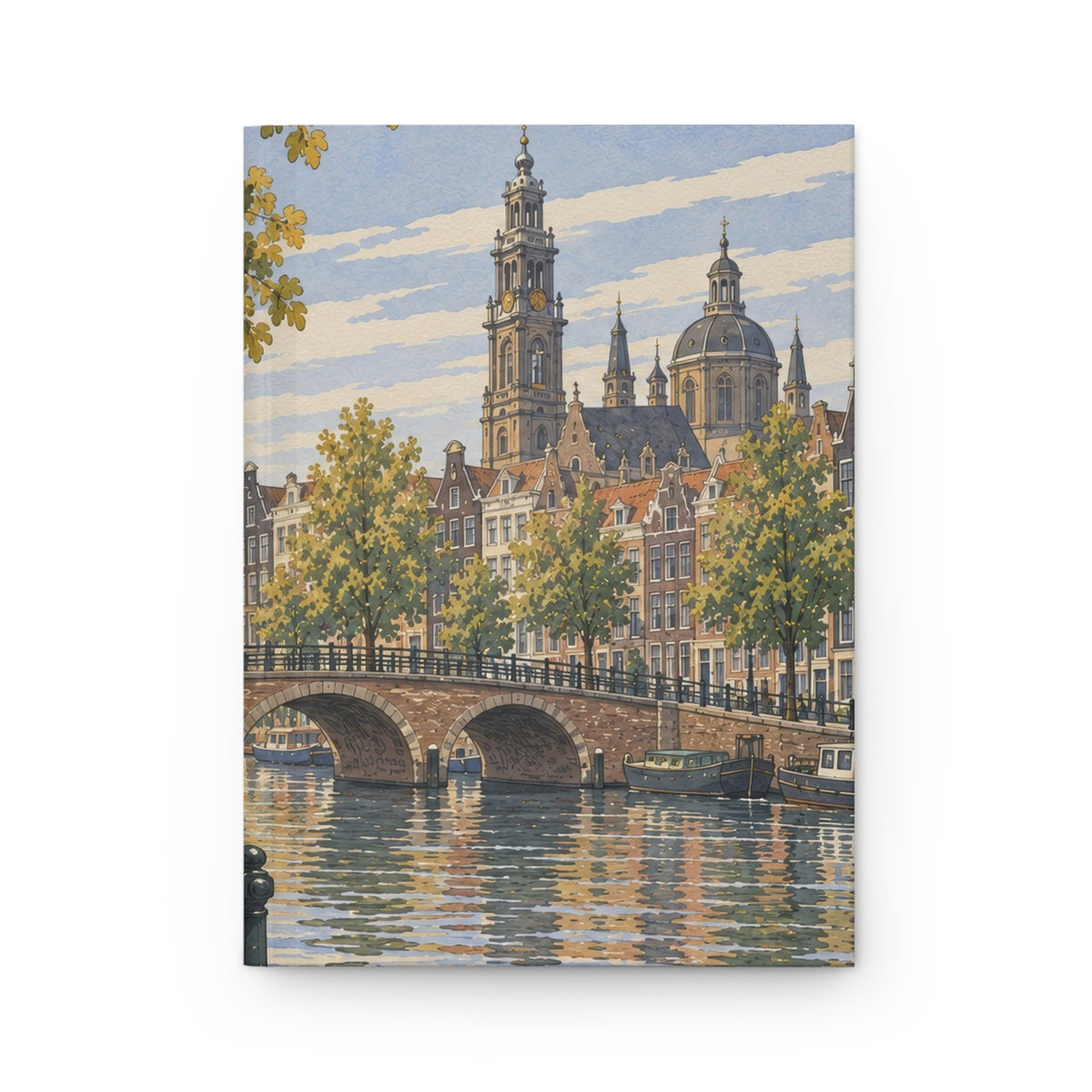 A hardcover notebook or journal featuring a watercolor-style illustration of a canal city scene with historic buildings, a stone bridge, trees, and boats, shown against a plain white background.