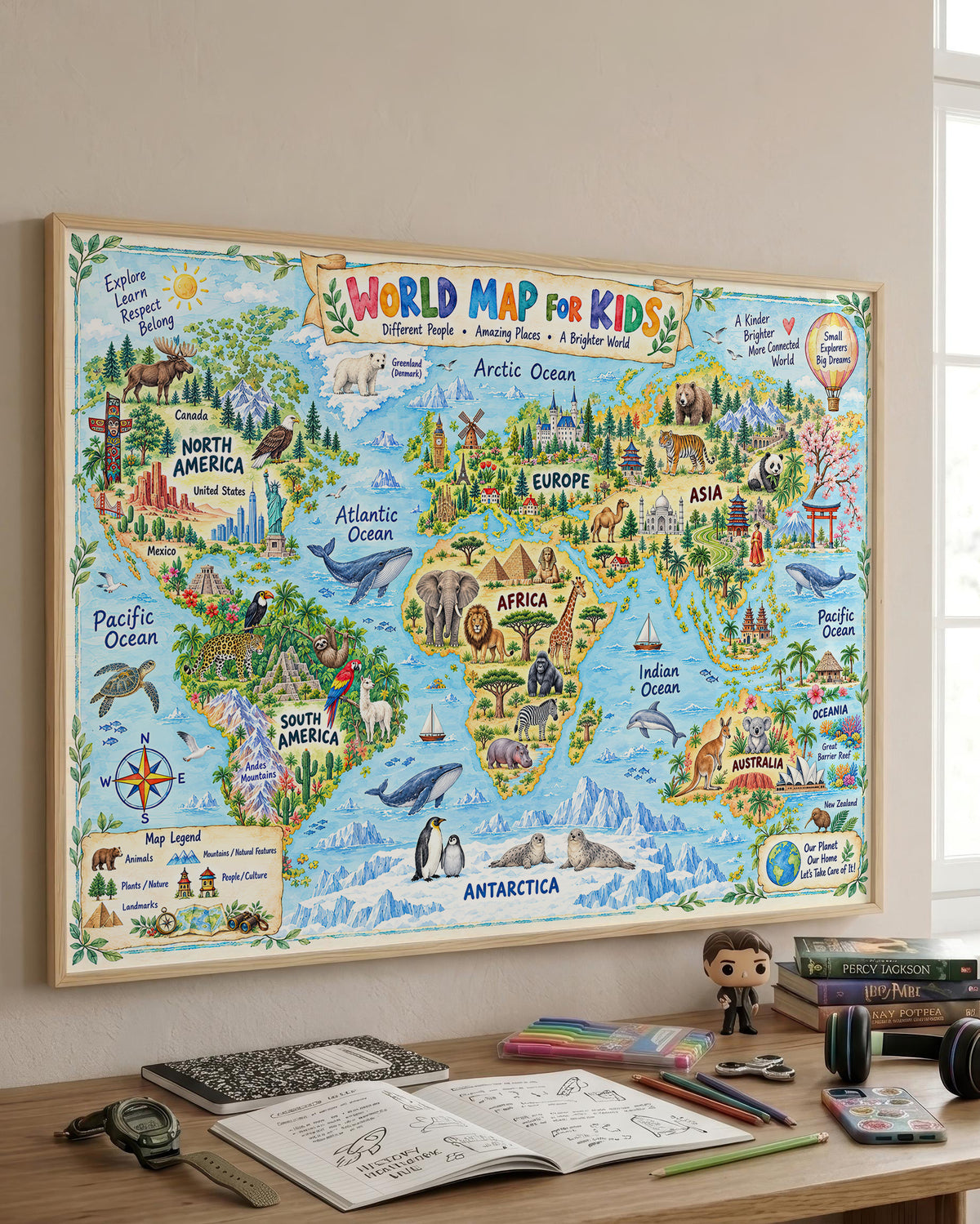 A colorful illustrated children's world map poster hanging on a wall above a desk with notebooks, pens, and a small figurine. The map shows continents, oceans, animals, and travel-themed illustrations, with the title 'World Map for Kids' at the top.