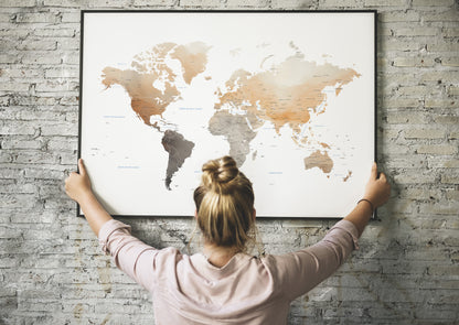 Watercolor world map large art in a black metal frame.