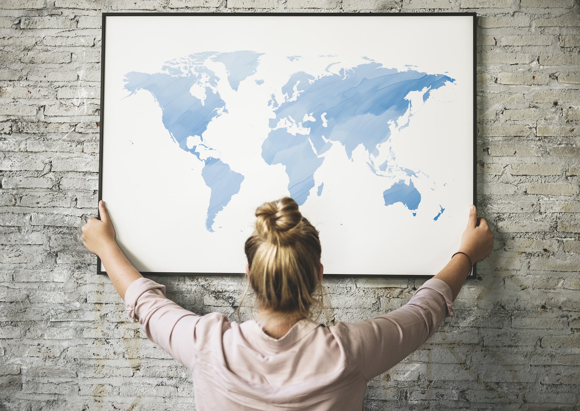 Watercolor world map wall art in blue tones.