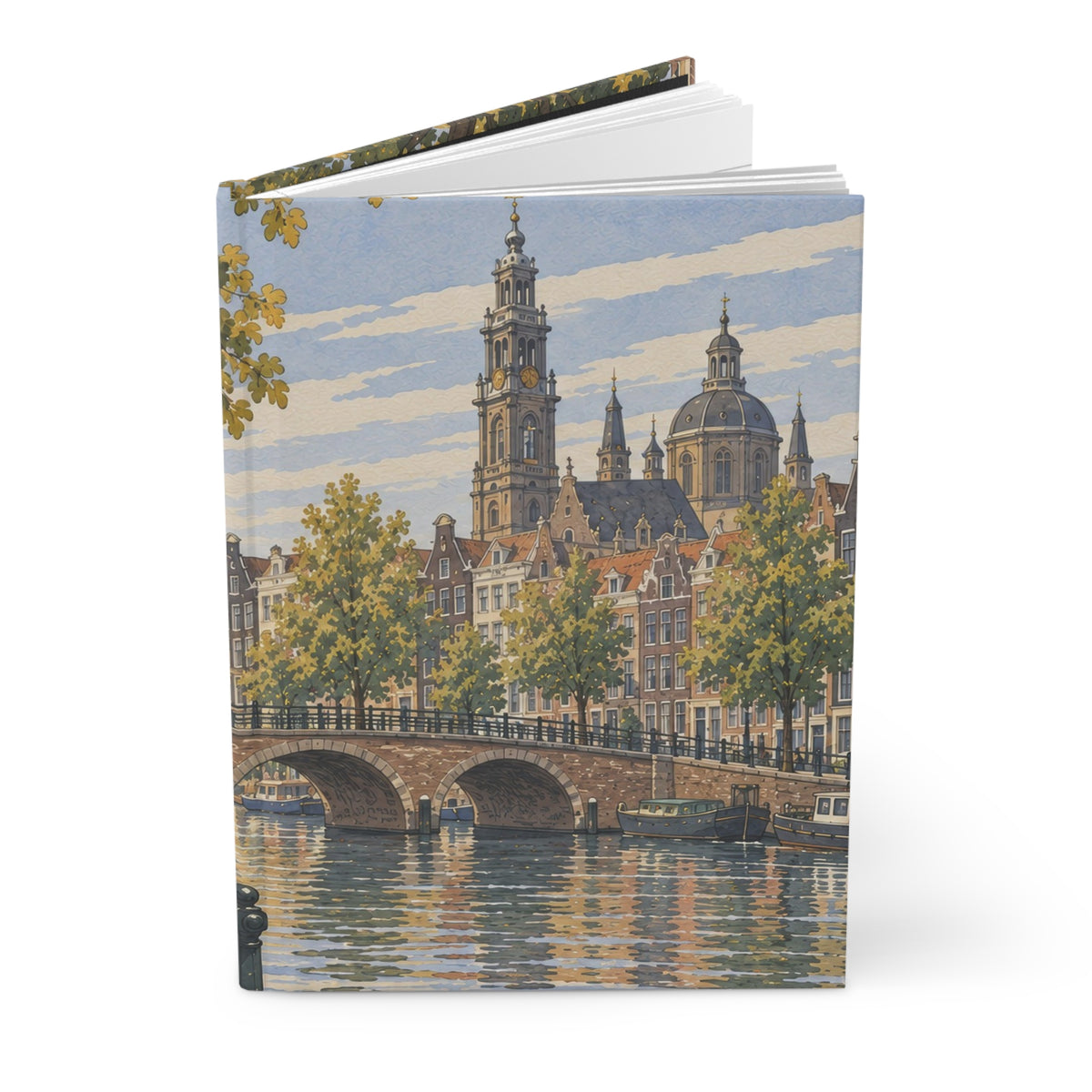 A hardcover notebook or journal standing upright, featuring a watercolor-style cityscape print on the cover with a canal, bridge, trees, and historic buildings under a blue sky.