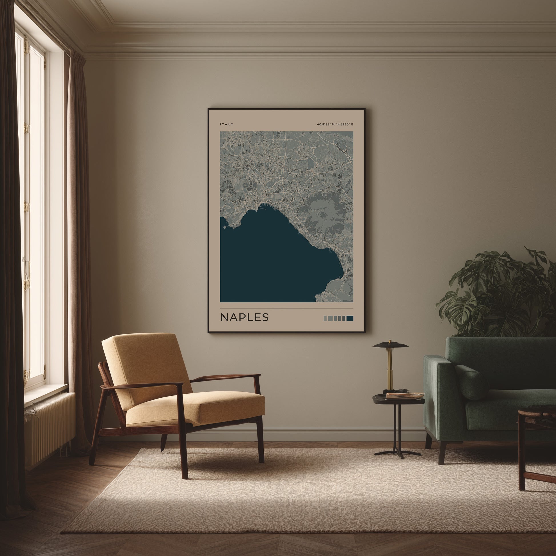 A framed art print of a Naples map hangs on a beige wall in a modern living room setting with a beige armchair, a green sofa, and a small side table.