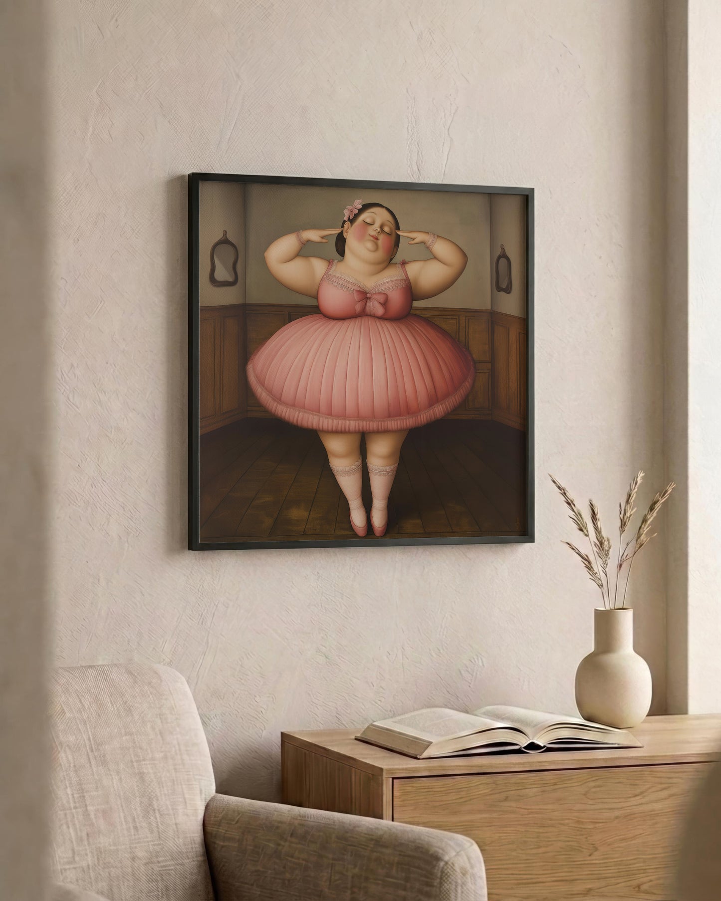A framed art print depicting a stylized, cartoonish woman in a pink dress standing in a room, displayed on a textured beige wall above a wooden console table with an open book and a vase.