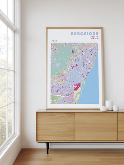 Framed map of Barcelona on a wall above a wooden cabinet.