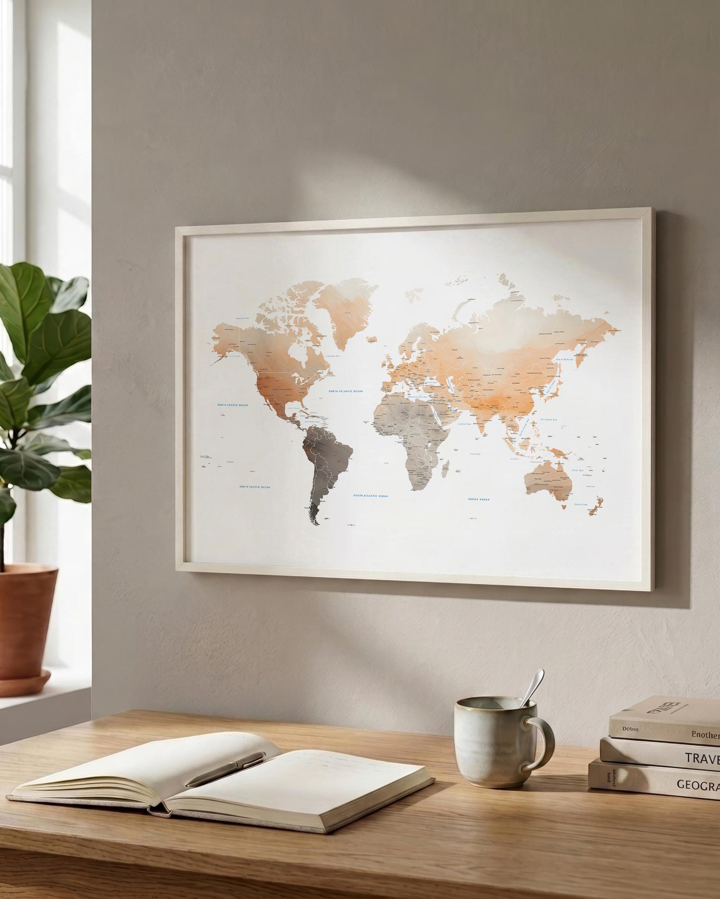 A framed world map print hangs on a beige wall above a wooden desk with an open book, a mug, and stacked books. A potted plant is visible at the left edge.