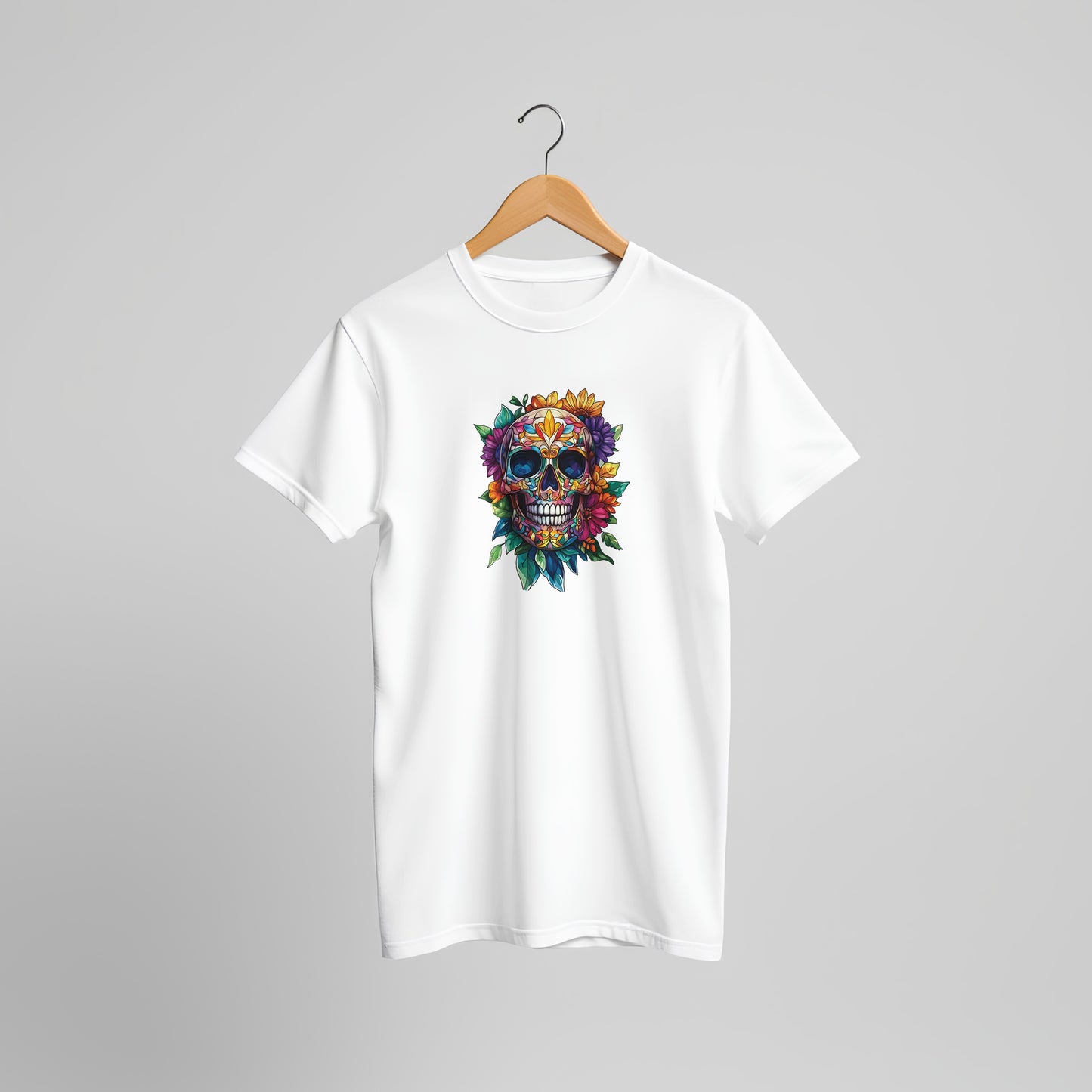 A white short-sleeve crewneck t-shirt hanging on a wooden hanger against a neutral gray background. The shirt features a colorful graphic of a sugar skull decorated with flowers and leaves on the center chest.