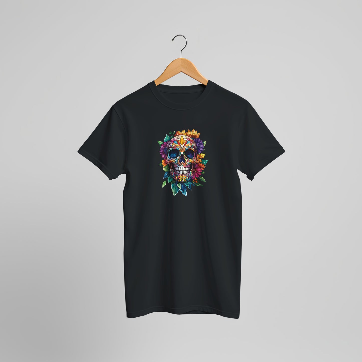 A black short-sleeve t-shirt hanging on a wooden hanger against a light gray background. The shirt features a colorful graphic of a sugar skull decorated with flowers and leaves on the center chest.