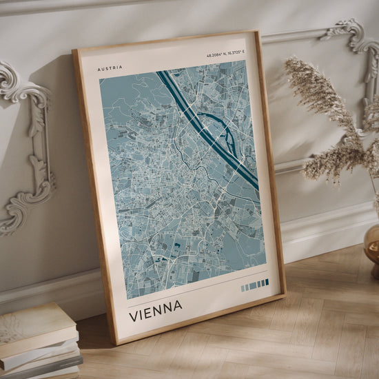 A Vienna city map print in blue tones in a  wood frame