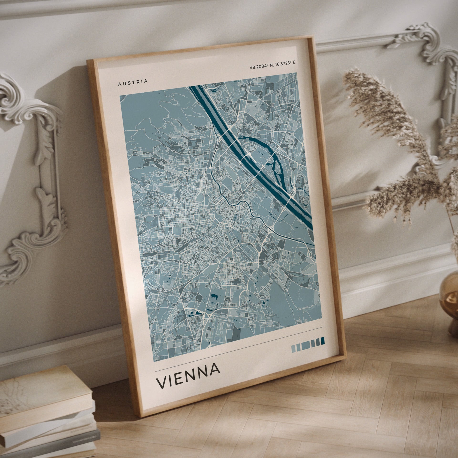 A Vienna city map print in blue tones in a  wood frame
