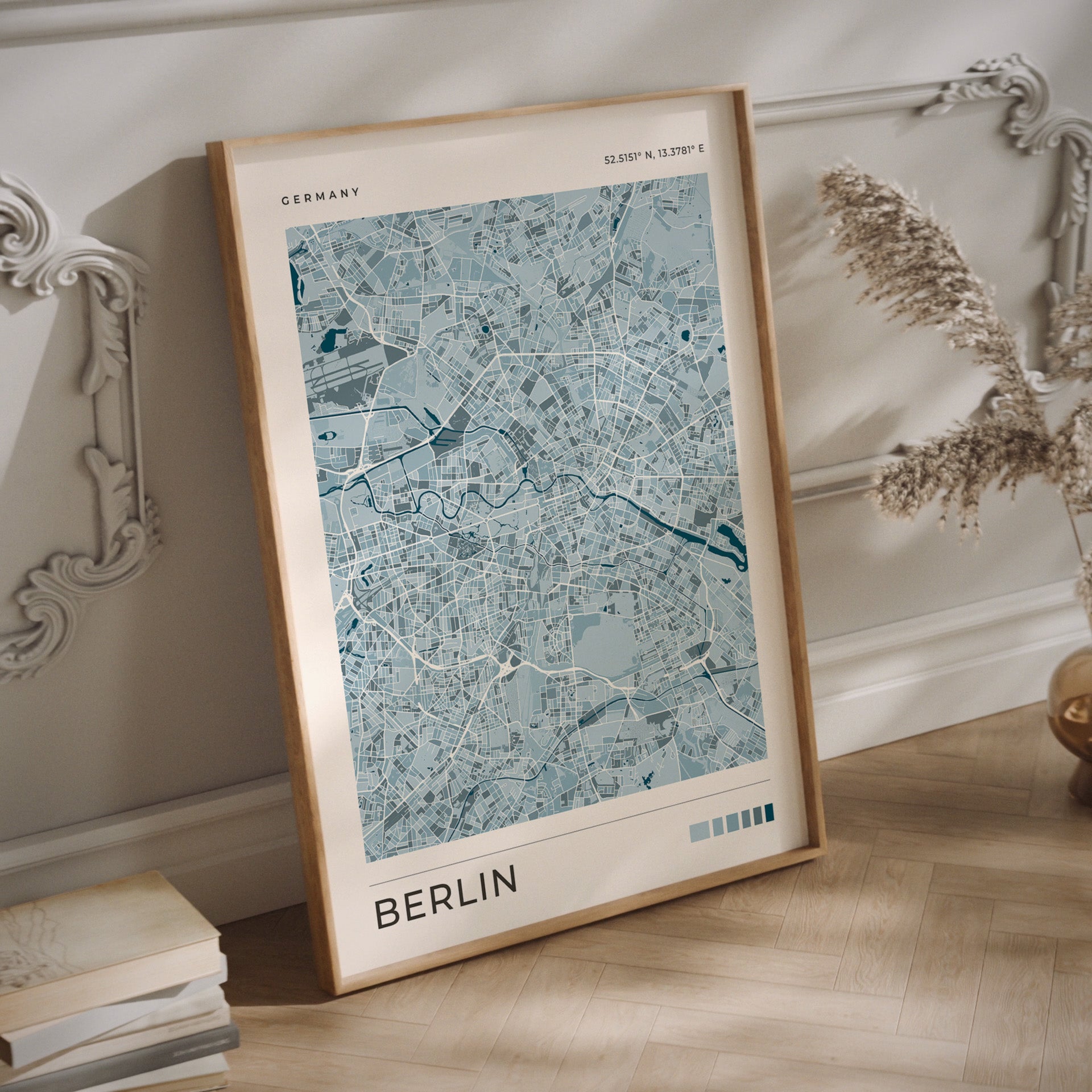 Minimalist Berlin map print in blue tones in a wood frame.