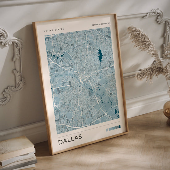 A blue Dallas city map print in a wood frame