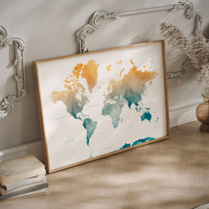 A yellow and teal watercolor world map print in a wood frame on the floor