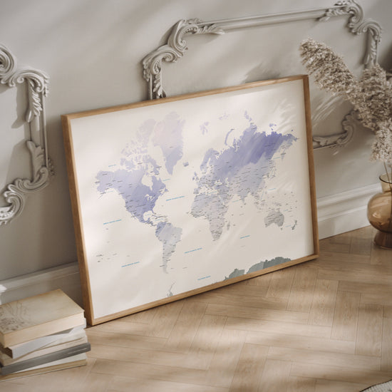 A lavender world map print in a wood frame