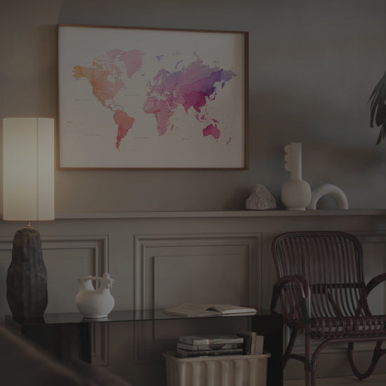 Watercolor world map art print in a wood frame.