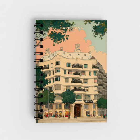 A spiral-bound notebook featuring a vintage-style Barcelona illustration on the cover, with the word 'BARCELONA' printed at the top and a black wire binding along the left side.